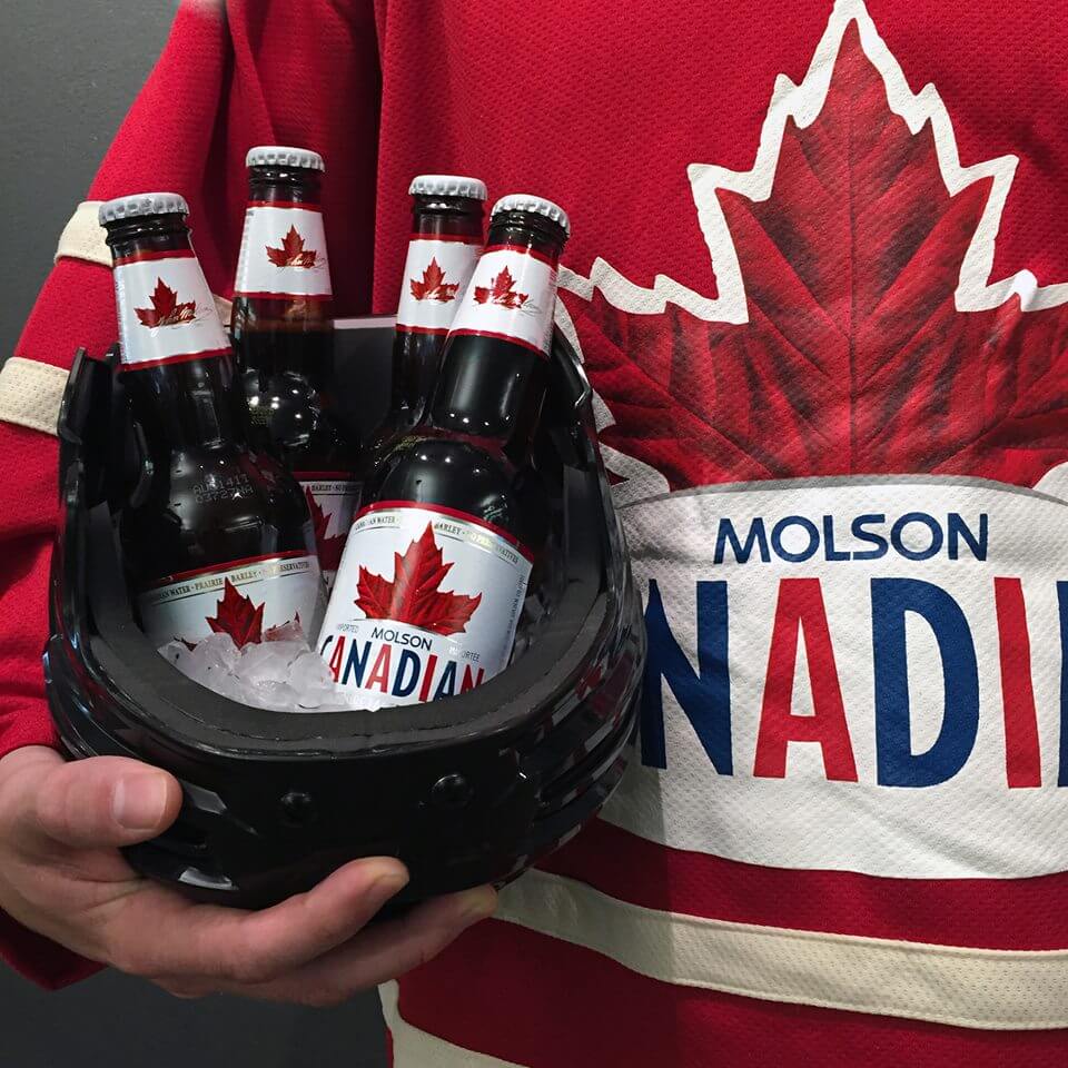 Person holding Molson Canadian Beer Bottles